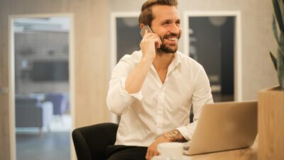 man using smartphone on chair
